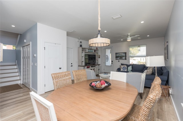 dining space featuring ceiling fan and light wood-type flooring