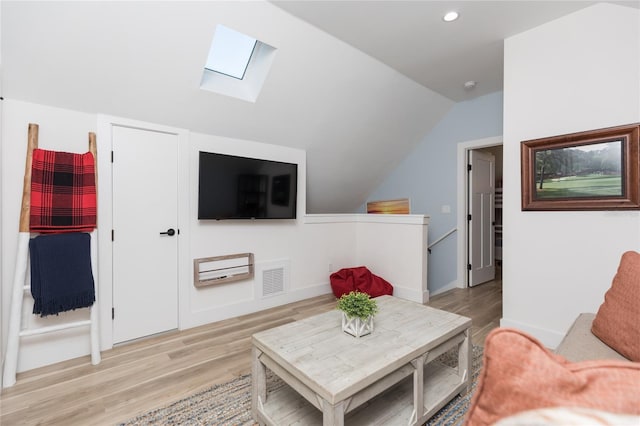 living room with light hardwood / wood-style floors and lofted ceiling