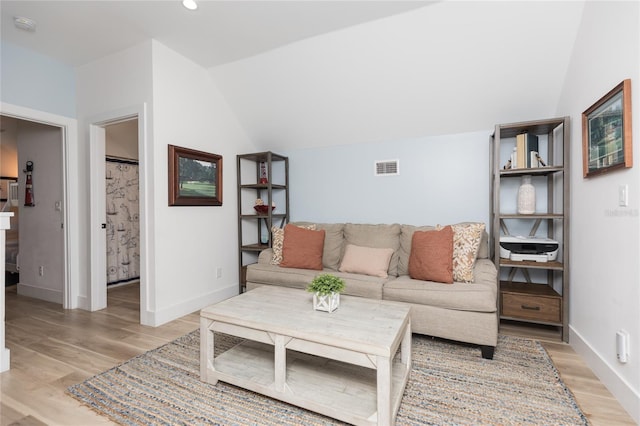 living room featuring light hardwood / wood-style floors and lofted ceiling