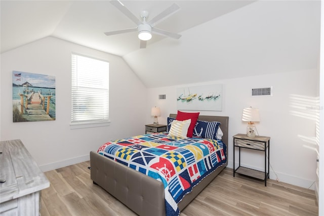 bedroom featuring ceiling fan, hardwood / wood-style floors, and lofted ceiling