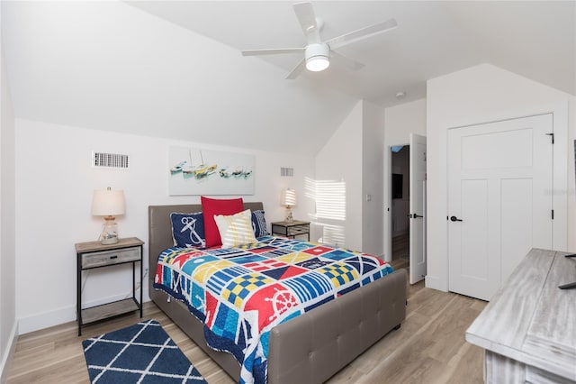 bedroom featuring ceiling fan, wood-type flooring, and vaulted ceiling