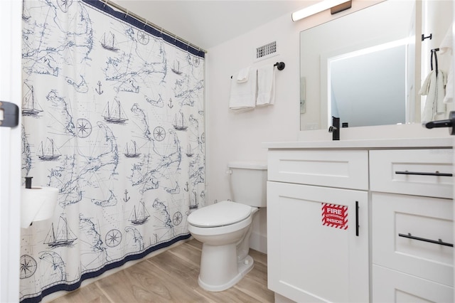 bathroom featuring hardwood / wood-style flooring, vanity, toilet, and a shower with shower curtain