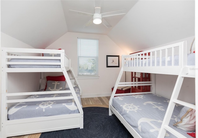 bedroom featuring ceiling fan, wood-type flooring, and vaulted ceiling