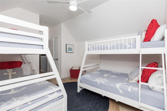 bedroom with hardwood / wood-style flooring, vaulted ceiling, and ceiling fan