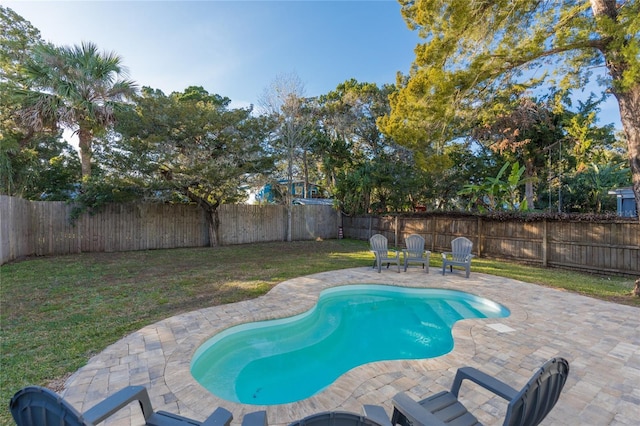 view of swimming pool featuring a yard and a patio