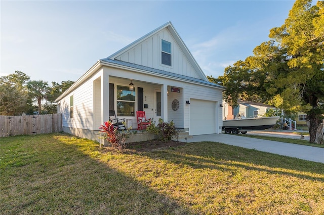 view of front facade featuring a garage, covered porch, and a front yard