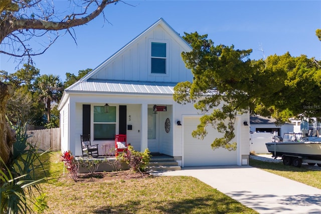 view of front facade featuring a garage, covered porch, and a front yard