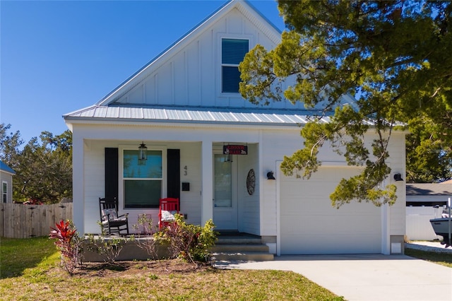 modern farmhouse with a porch and a garage