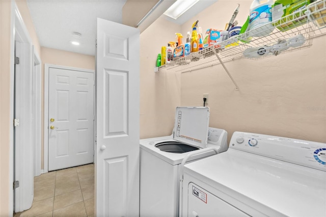 washroom with independent washer and dryer and light tile patterned floors