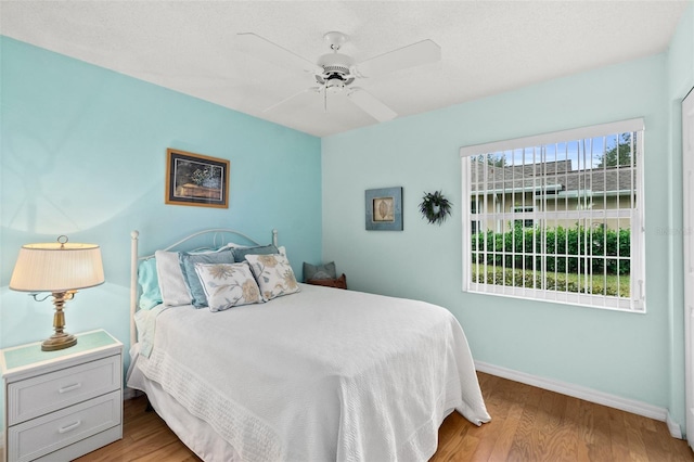 bedroom with ceiling fan and light wood-type flooring