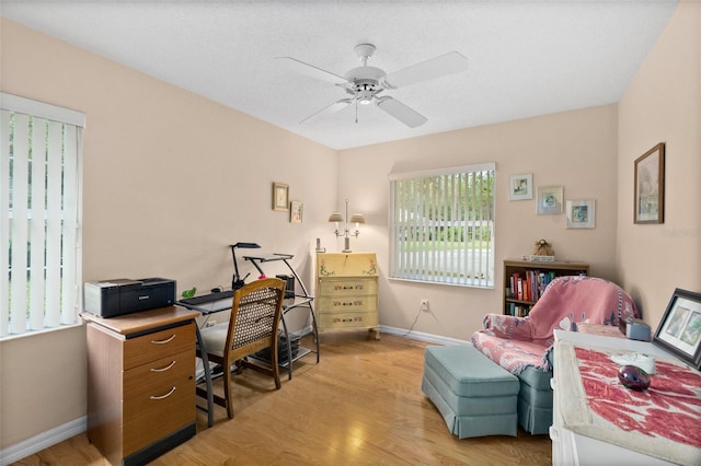 office area with light hardwood / wood-style floors and ceiling fan