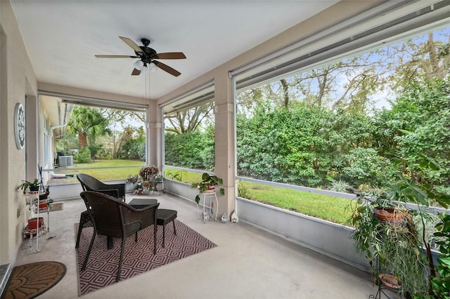 sunroom / solarium featuring ceiling fan