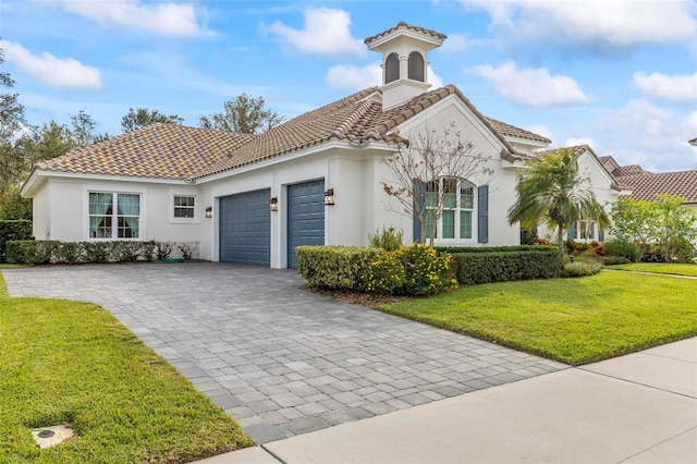 mediterranean / spanish-style home featuring a garage and a front lawn