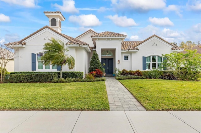 mediterranean / spanish-style house with a front lawn