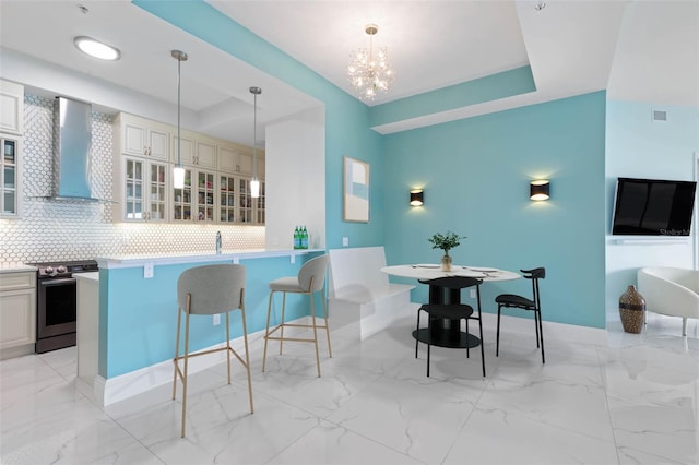 kitchen with a breakfast bar, wall chimney range hood, hanging light fixtures, stainless steel electric range oven, and tasteful backsplash