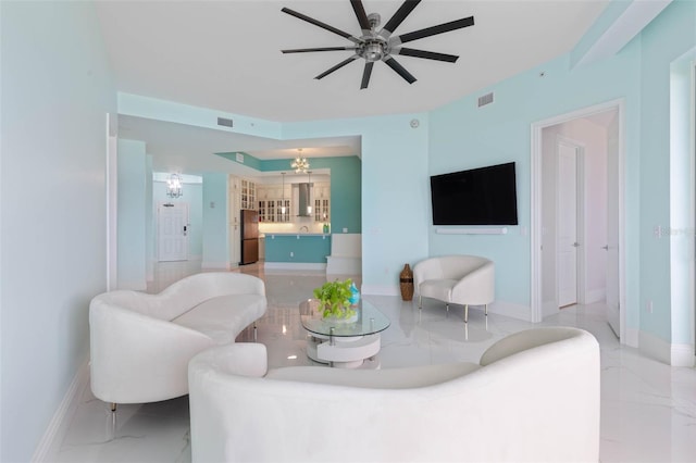 living room featuring ceiling fan with notable chandelier