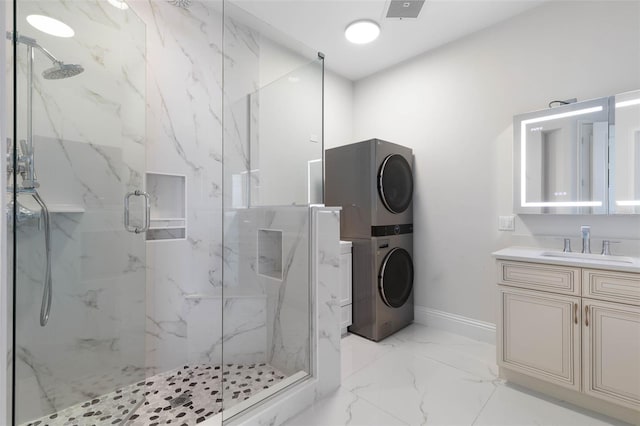 bathroom with vanity, an enclosed shower, and stacked washer / dryer