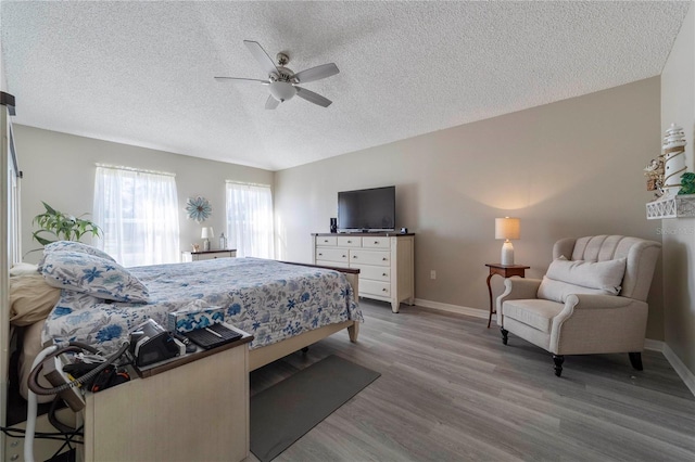 bedroom featuring hardwood / wood-style flooring, ceiling fan, and a textured ceiling