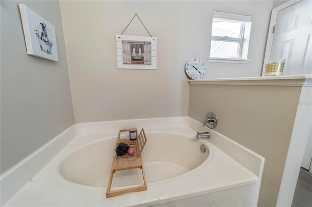 bathroom featuring tiled tub