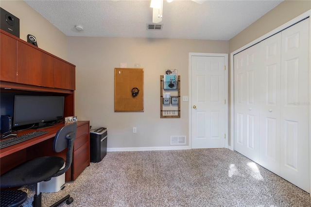 office area featuring light colored carpet and a textured ceiling