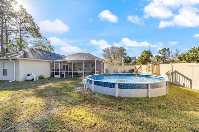 view of swimming pool with glass enclosure and a yard