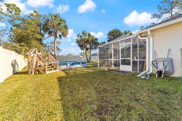 view of yard with a fenced in pool and a lanai