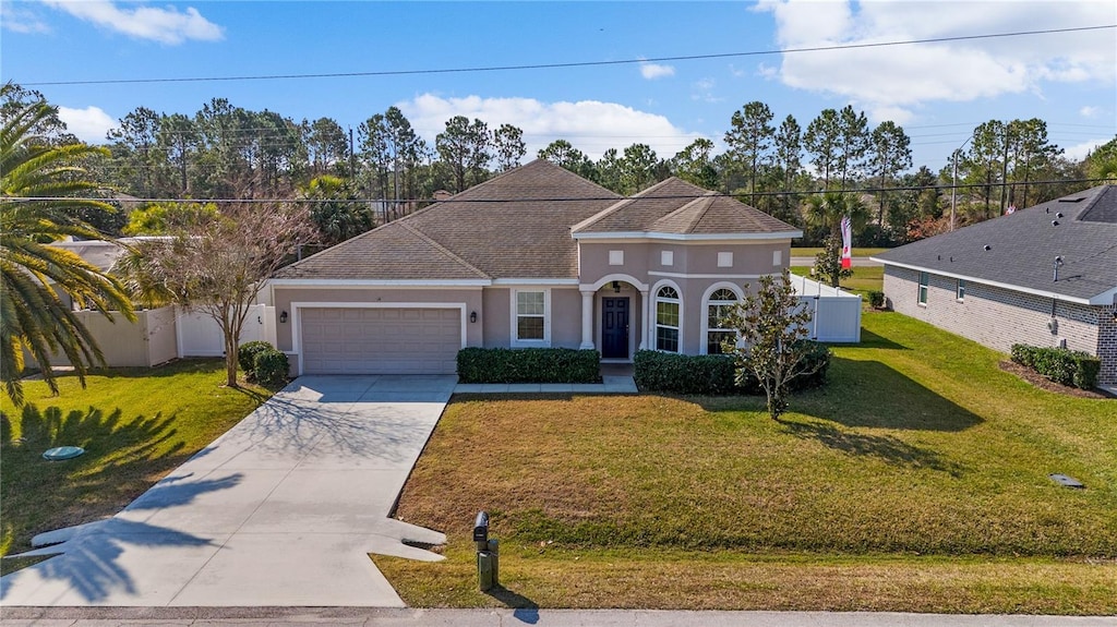 view of front of home with a garage and a front yard