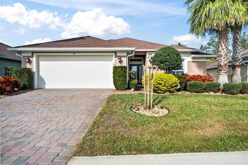 view of front facade with a garage and a front lawn