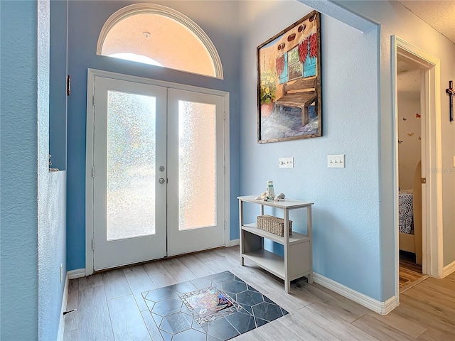 interior space with light hardwood / wood-style floors and french doors