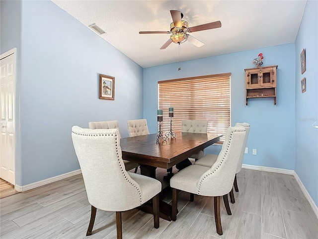 dining area featuring ceiling fan, light hardwood / wood-style floors, and a textured ceiling