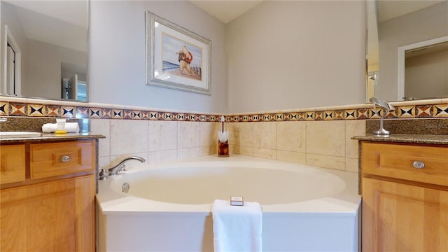 bathroom with vanity, tile walls, and a washtub