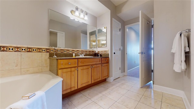 bathroom featuring tile patterned flooring, vanity, and a tub