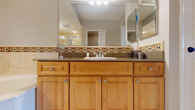 bathroom featuring shower with separate bathtub and vanity