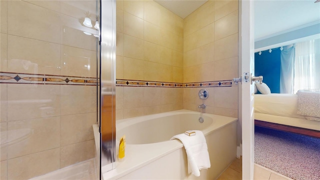 bathroom featuring tile patterned flooring and a tub to relax in