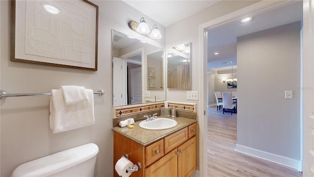 bathroom featuring hardwood / wood-style floors, vanity, and toilet