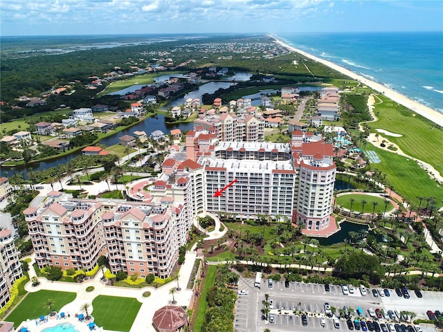 birds eye view of property with a view of the beach and a water view