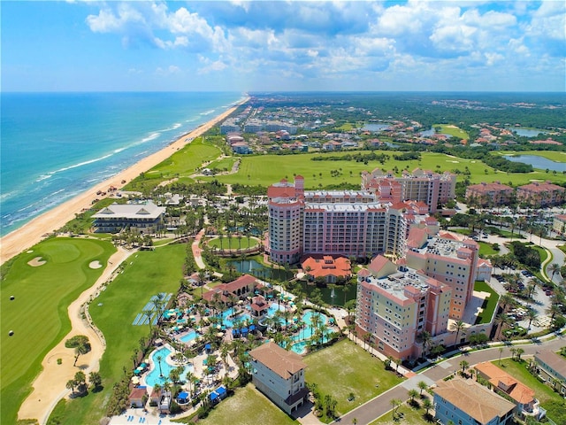 birds eye view of property with a water view and a beach view