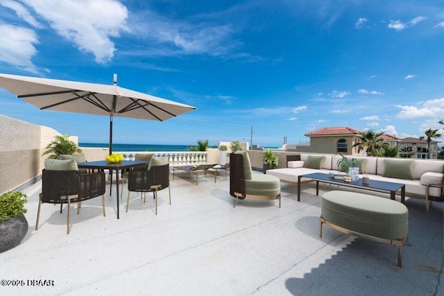 view of patio / terrace featuring a water view and outdoor lounge area