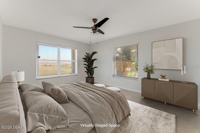 bedroom with ceiling fan and hardwood / wood-style flooring