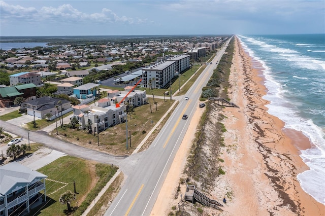 drone / aerial view with a water view and a view of the beach