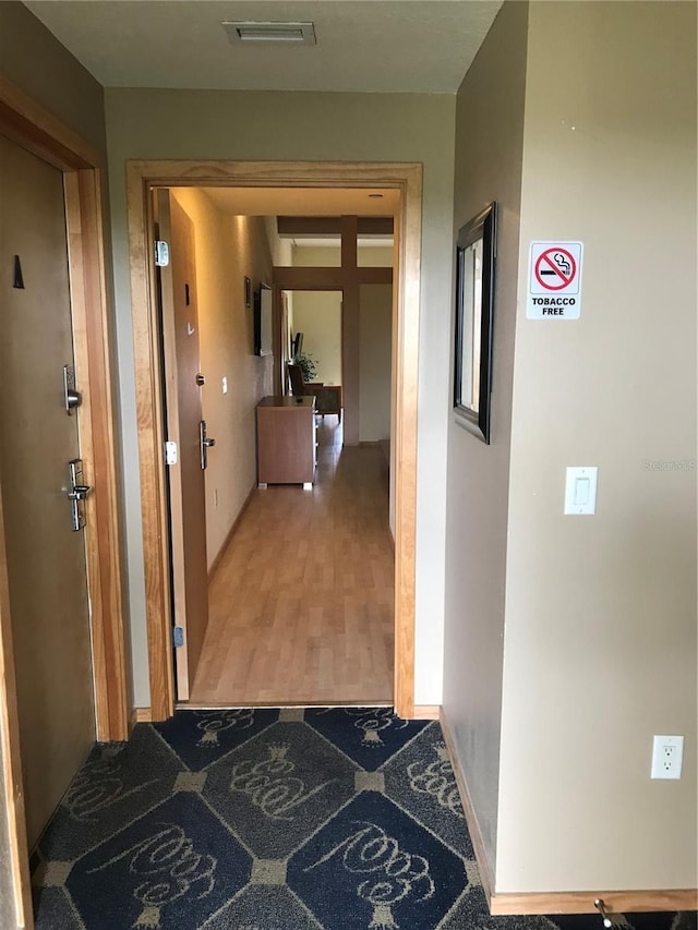 hallway with wood-type flooring