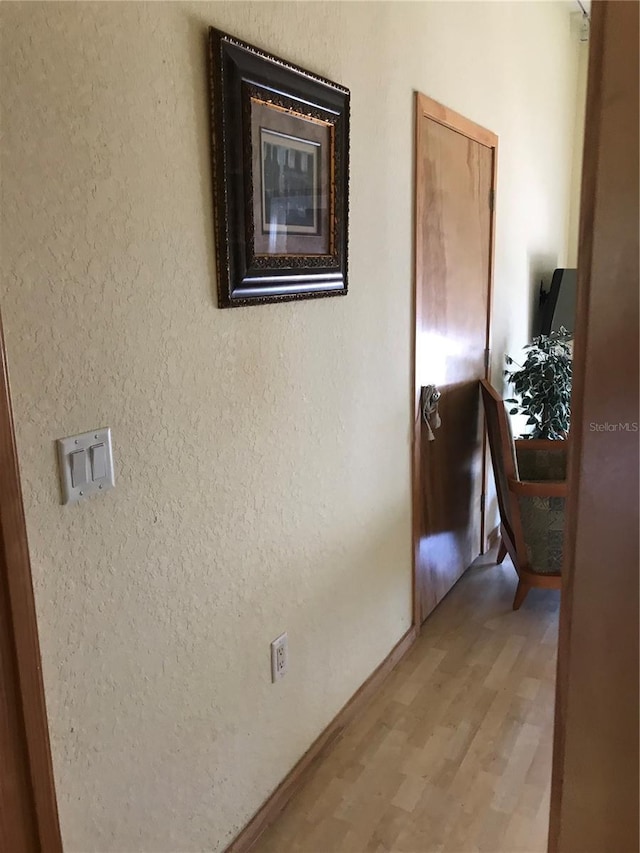 hallway with light hardwood / wood-style flooring