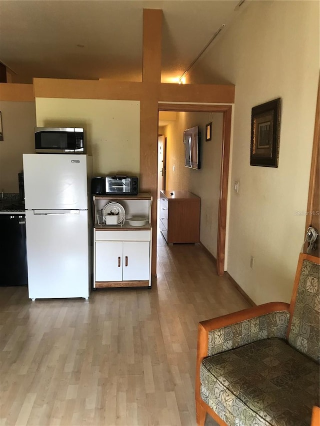 kitchen with dishwasher, white fridge, and light hardwood / wood-style floors