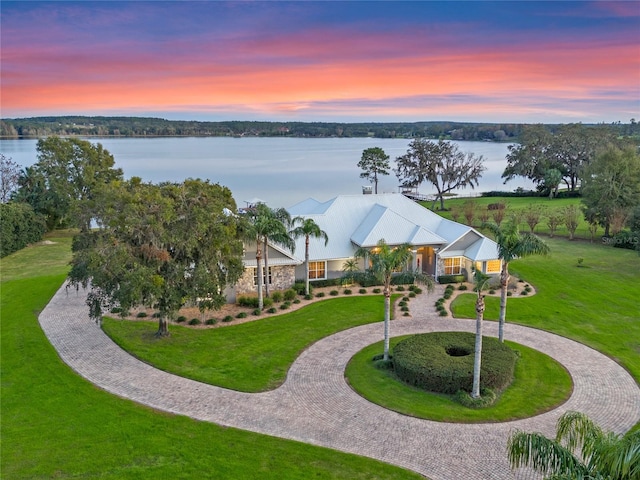 aerial view at dusk with a water view