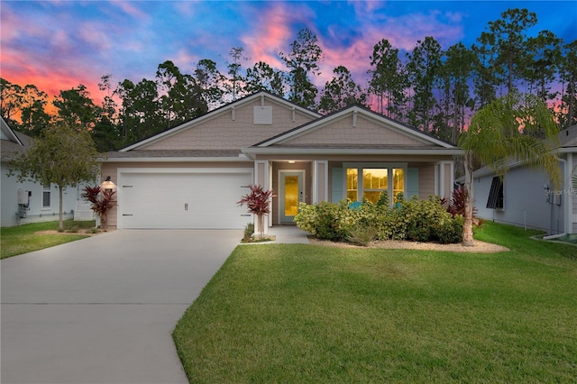 view of front of home featuring a garage and a lawn