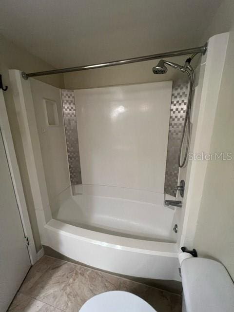 bathroom featuring toilet and shower / washtub combination