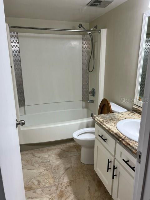 full bathroom with shower / bathing tub combination, vanity, and toilet