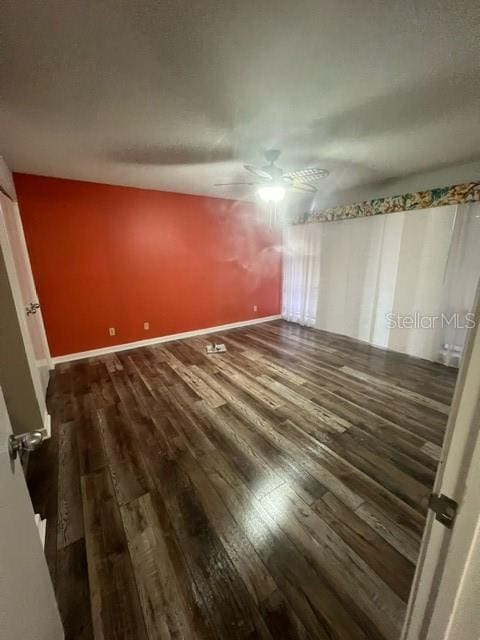 unfurnished bedroom featuring dark hardwood / wood-style flooring and ceiling fan