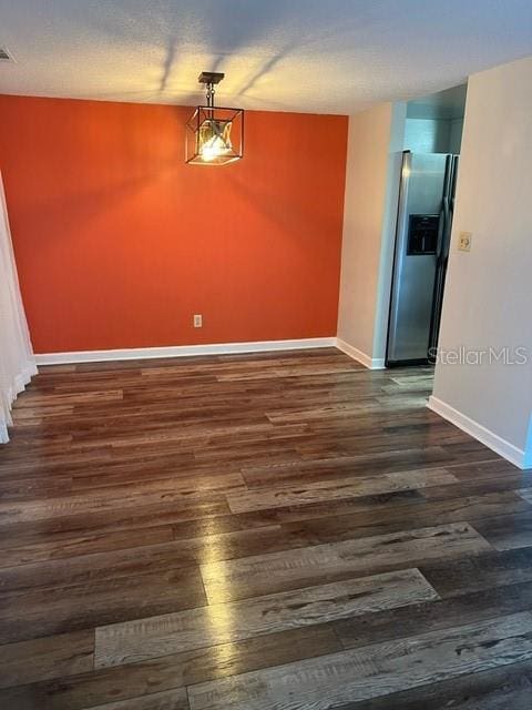 unfurnished dining area with dark hardwood / wood-style floors