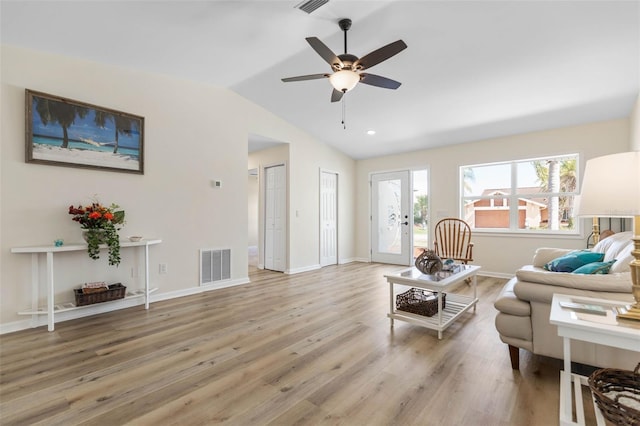 living room with french doors, ceiling fan, hardwood / wood-style floors, and lofted ceiling